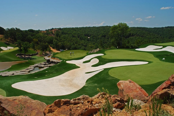Austin lush green synthetic grass golf course with white sand bunkers and blue sky